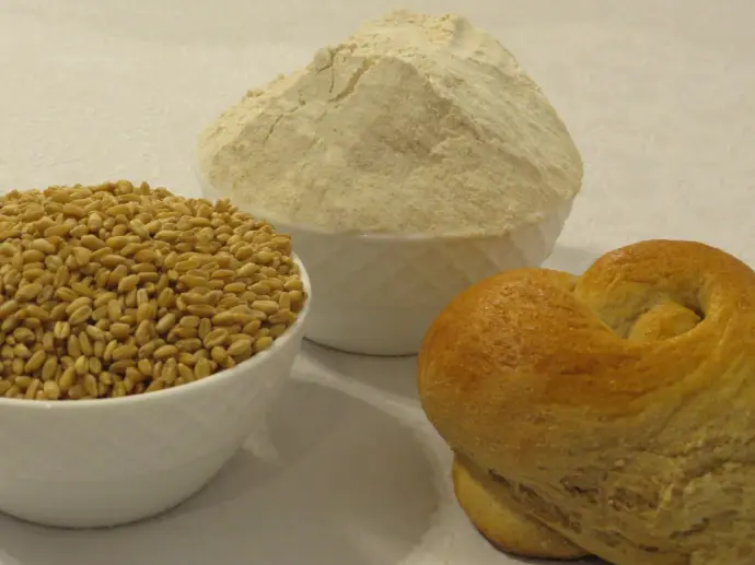 three different types of bread in bowls on a table